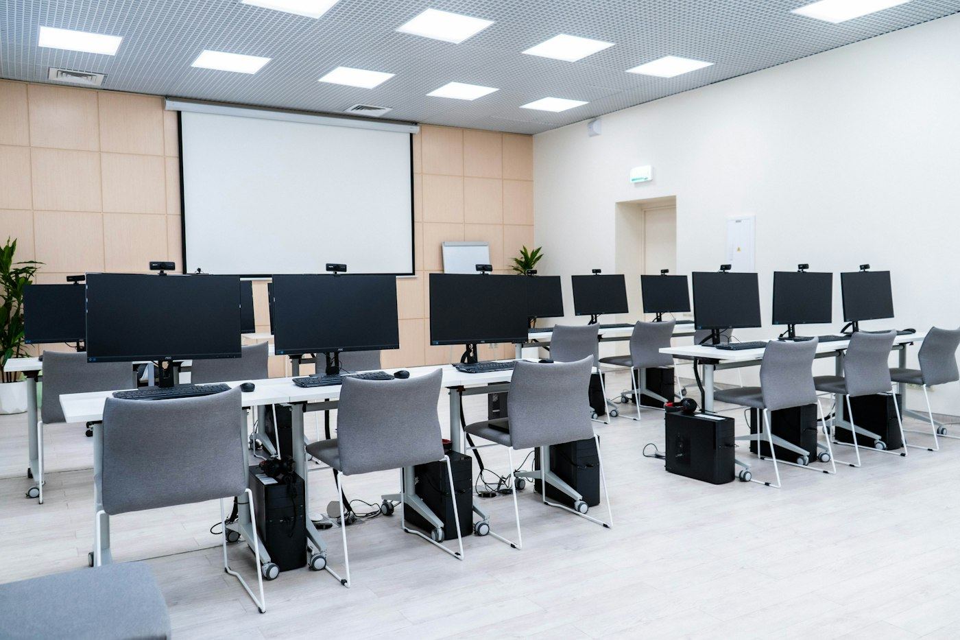 Empty computer lab with rows of desktop PCs